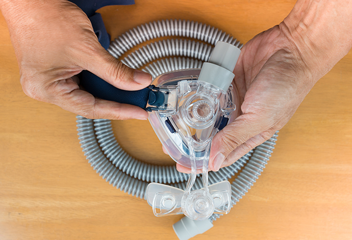 family-doctor-046 Pair of CPAP mask and tubing.<br />
Cleaning cpap mask and tubing is a routine job,selective focus on cpap mask,flat lay